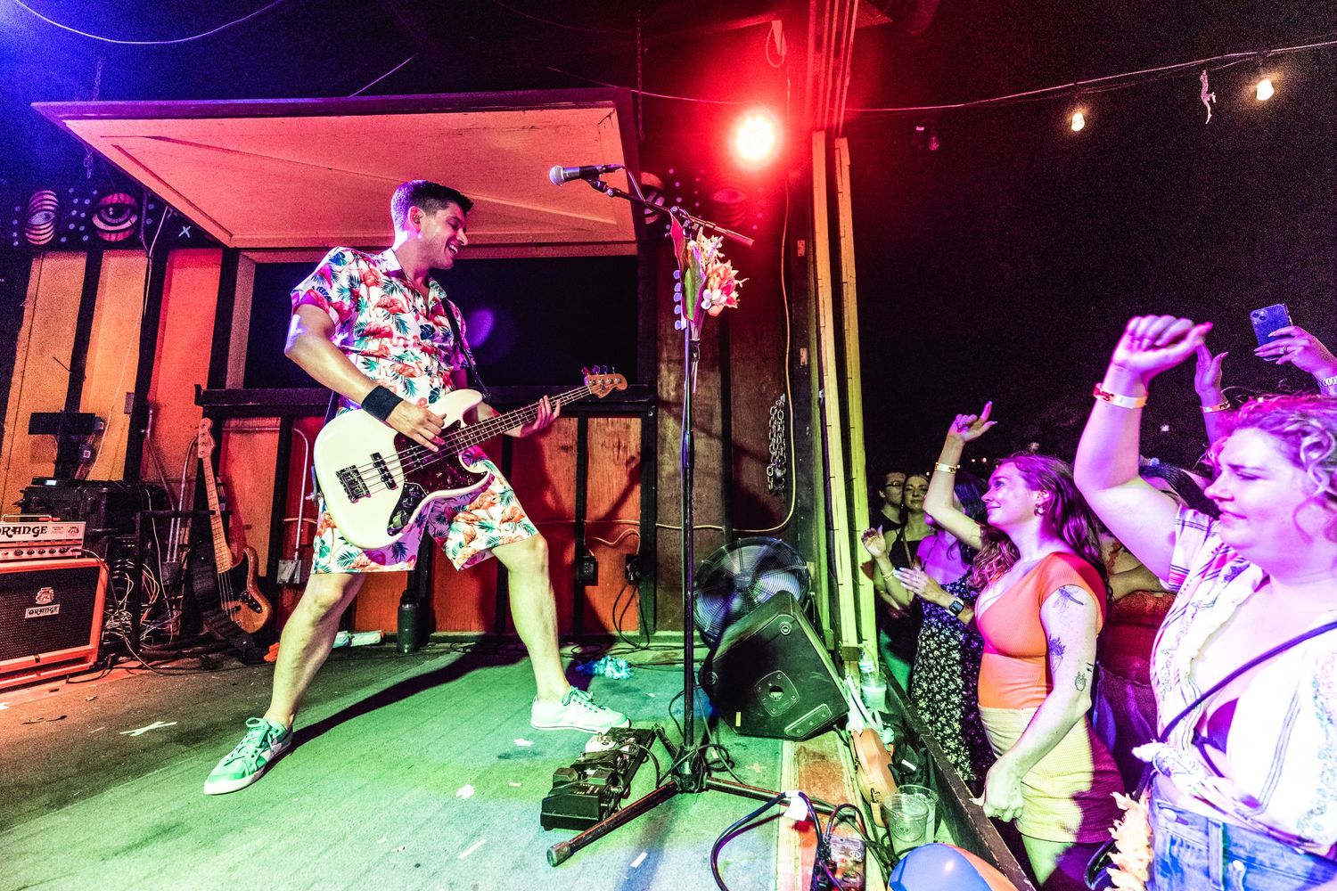 Energetic performance on stage with colorful red and blue lighting effects.