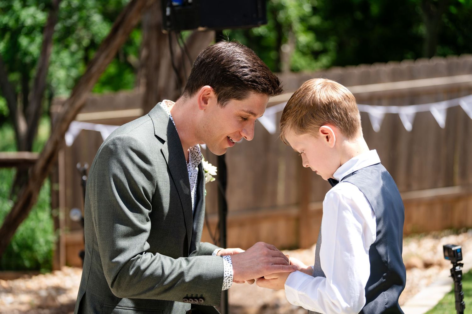 A tender moment between two wedding attendants getting ready outdoors.