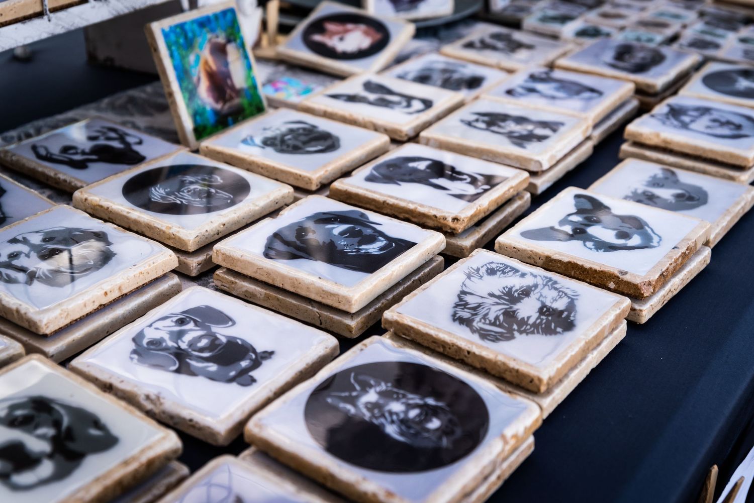 Vintage-style photographs arranged in wooden frames displayed on a market table.