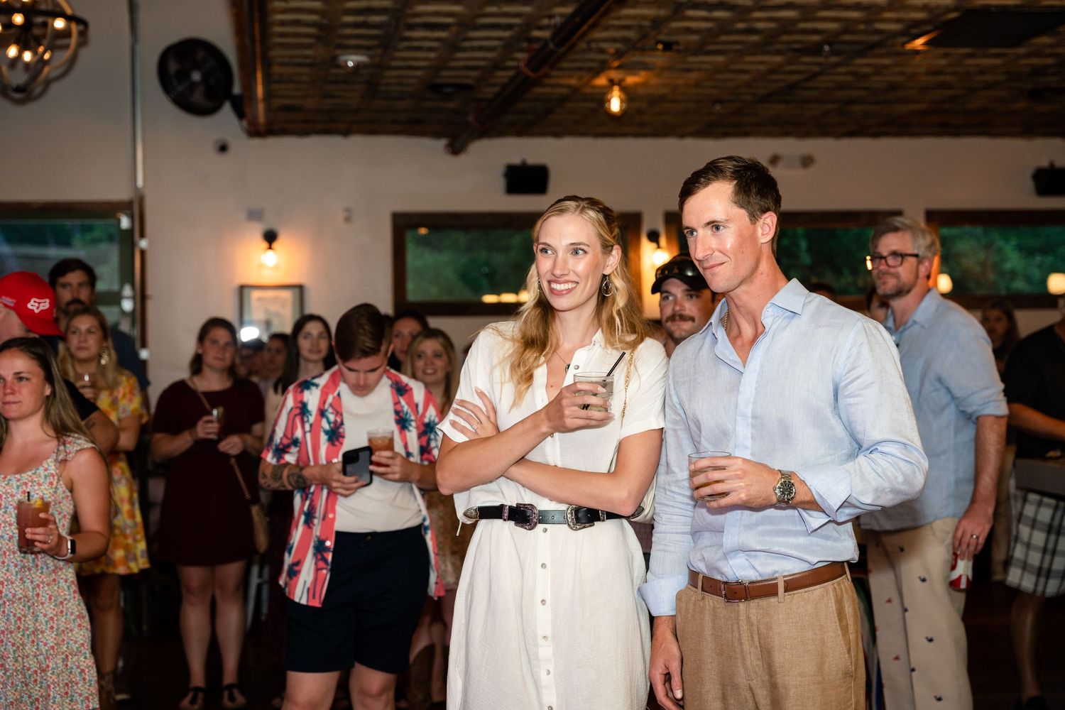 Attendees watching a performance at an indoor social event.