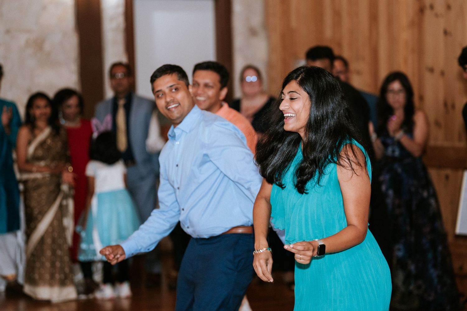 Party guests dancing and enjoying themselves at a multicultural celebration.