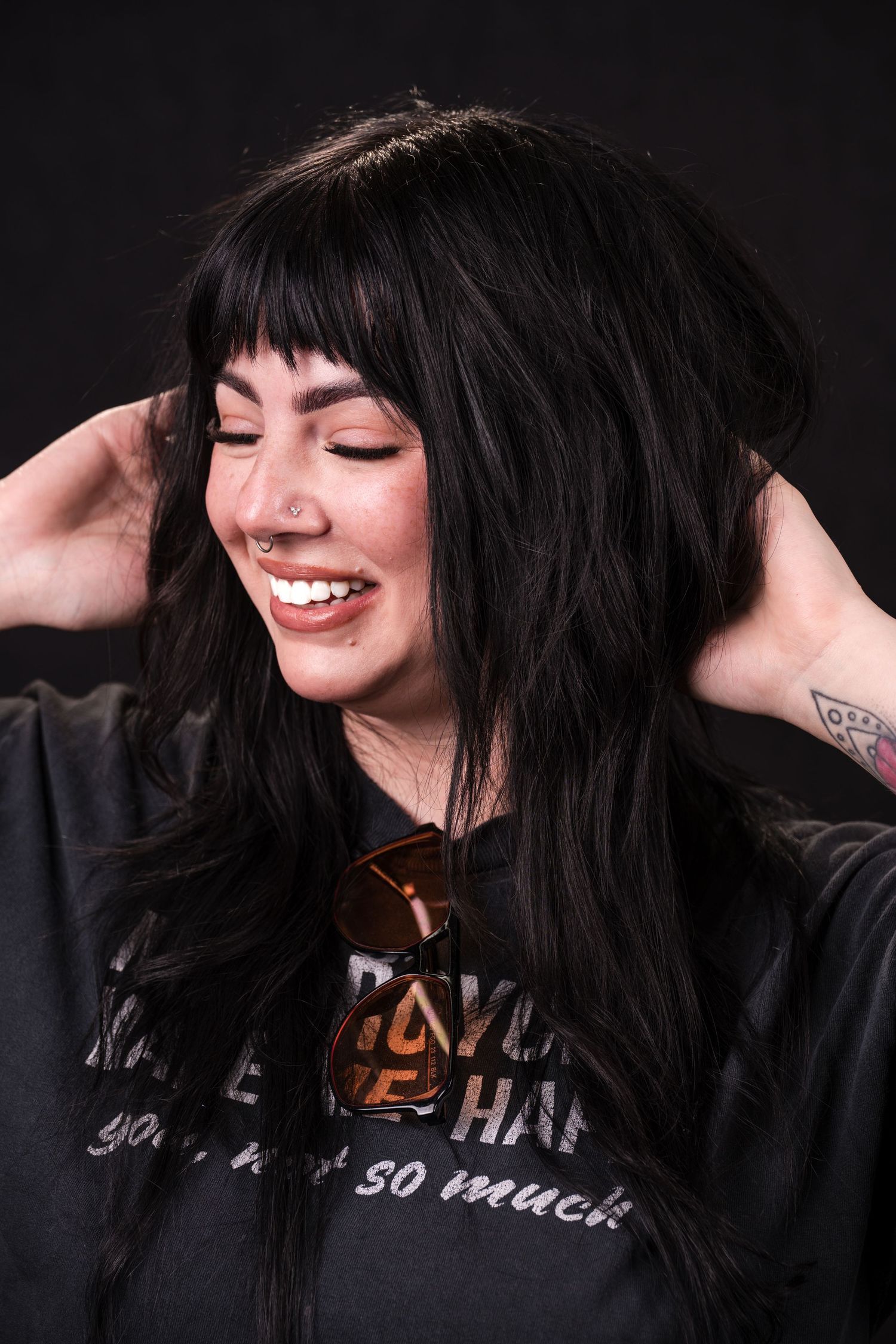 A series of black and white portraits showing joyful expressions and movement against a dark background.