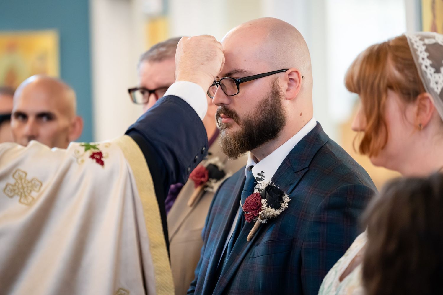 A group of wedding guests mingle and socialize at an elegant indoor reception venue.