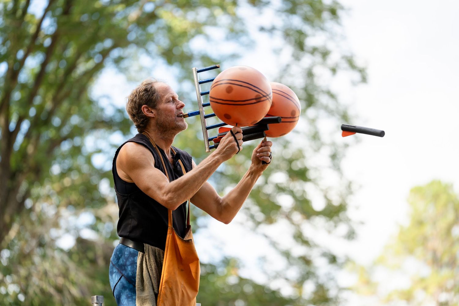 A sequence of photos showing someone attempting to drink from a basketball while standing outdoors.