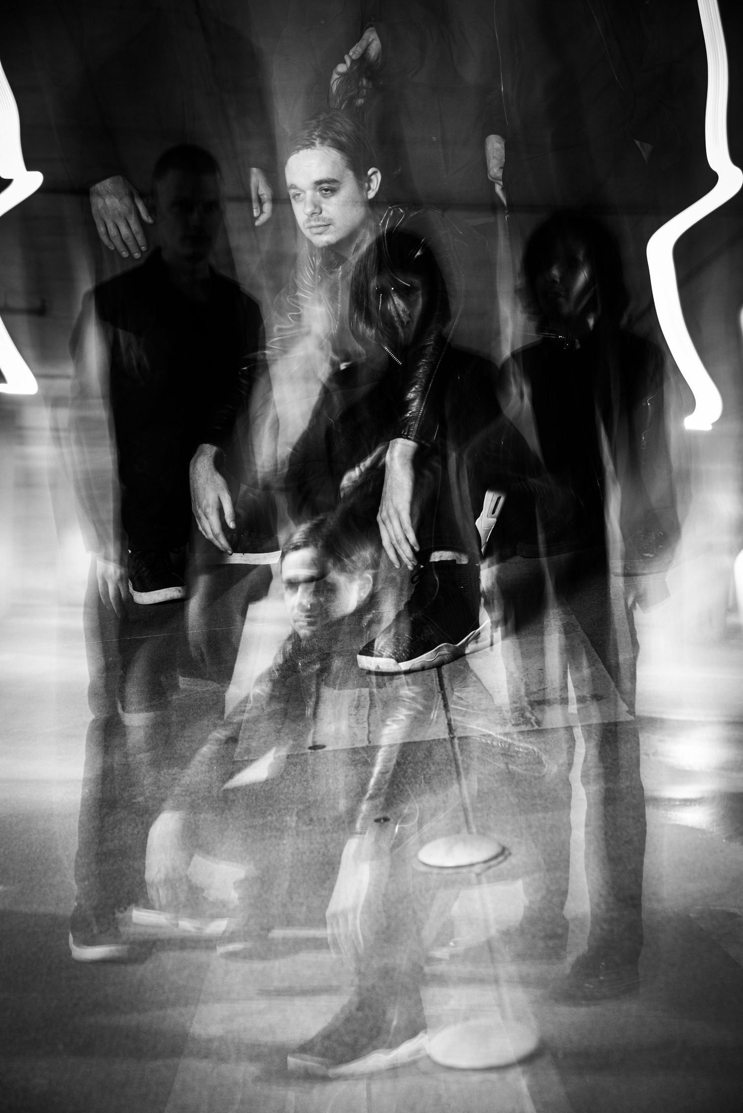 Long exposure black and white photo shows blurred motion of dancers' feet on a dance floor.