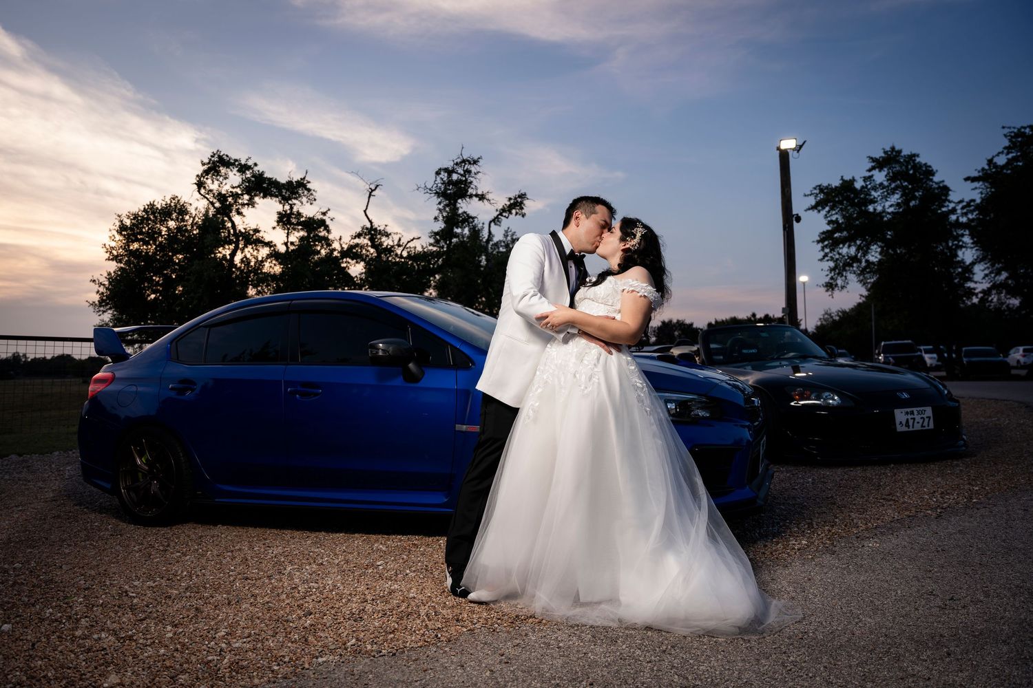 A set of romantic wedding photos taken at sunset featuring a blue vintage car and newlyweds posing together outside.