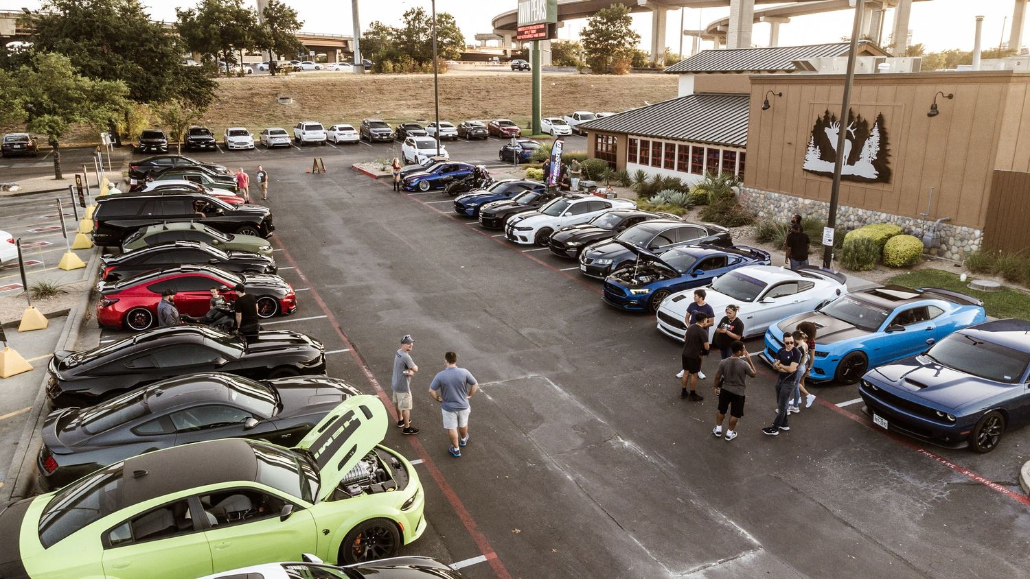 High angle shot of cars parked in rows at a shopping complex.
