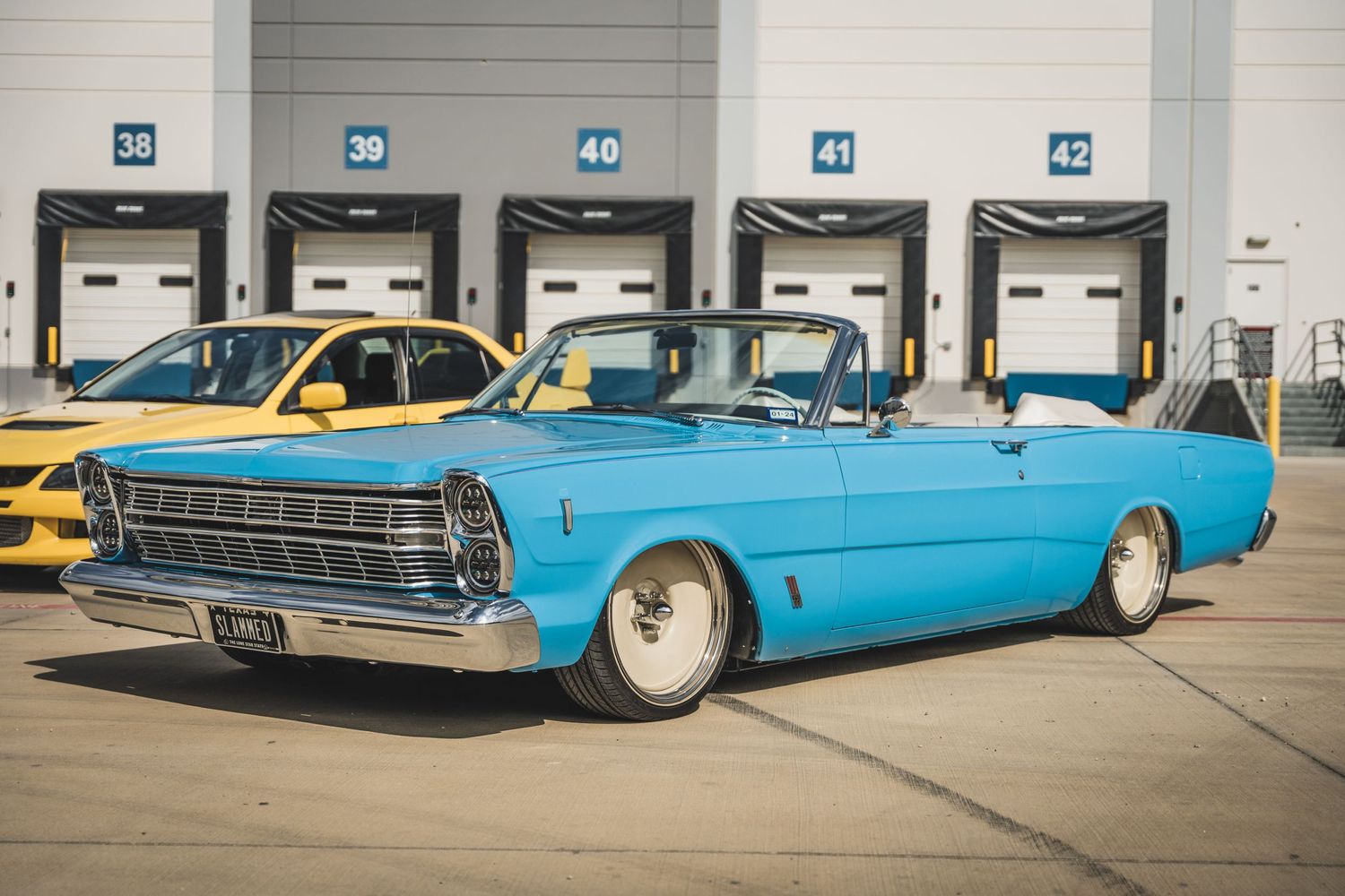 Custom light blue vintage Ford Galaxie convertible lowrider with chrome trim.