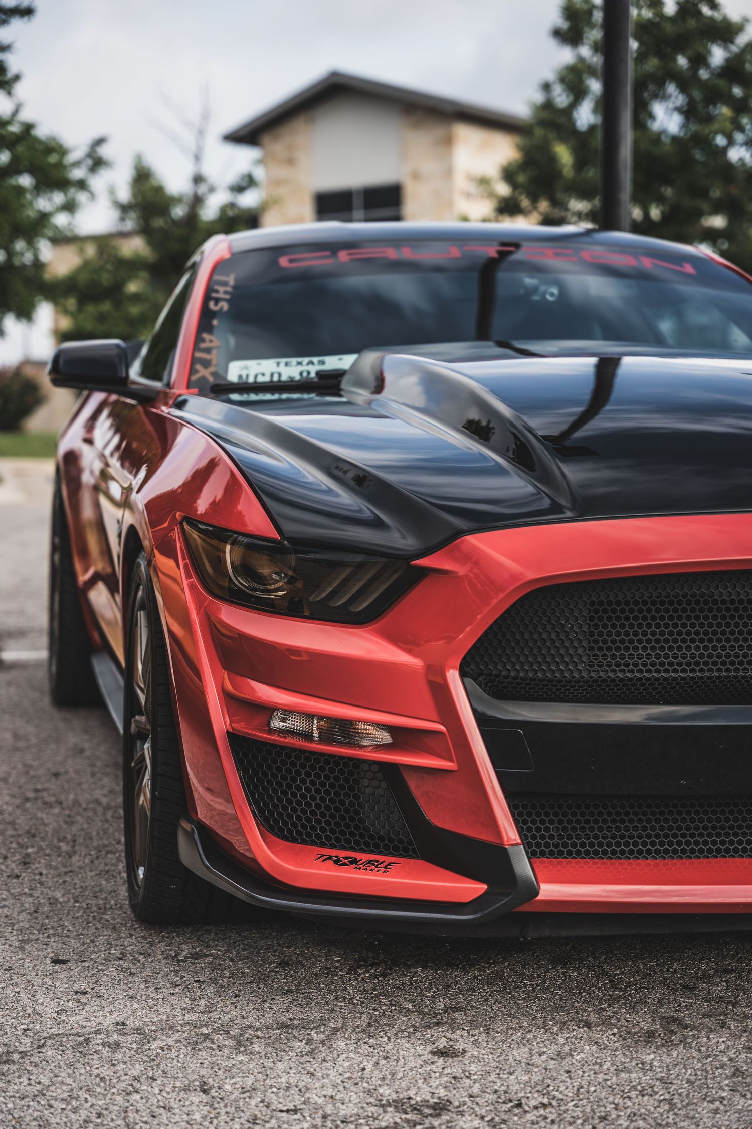 Front view of a red and black Ford Mustang Shelby GT500 showing aggressive front grille design.