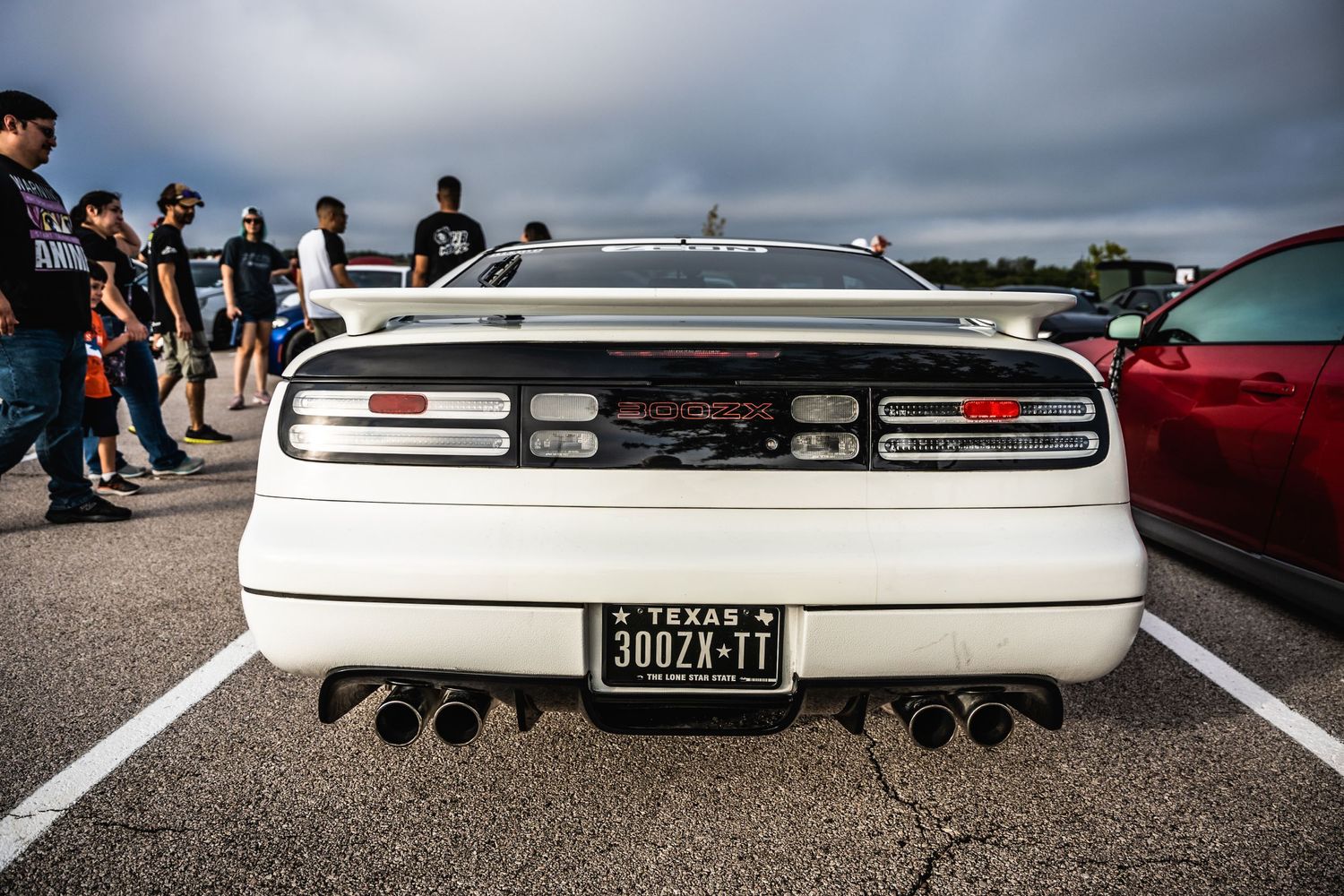 Rear view of classic white Nissan 300ZX showing taillights and quad exhaust.