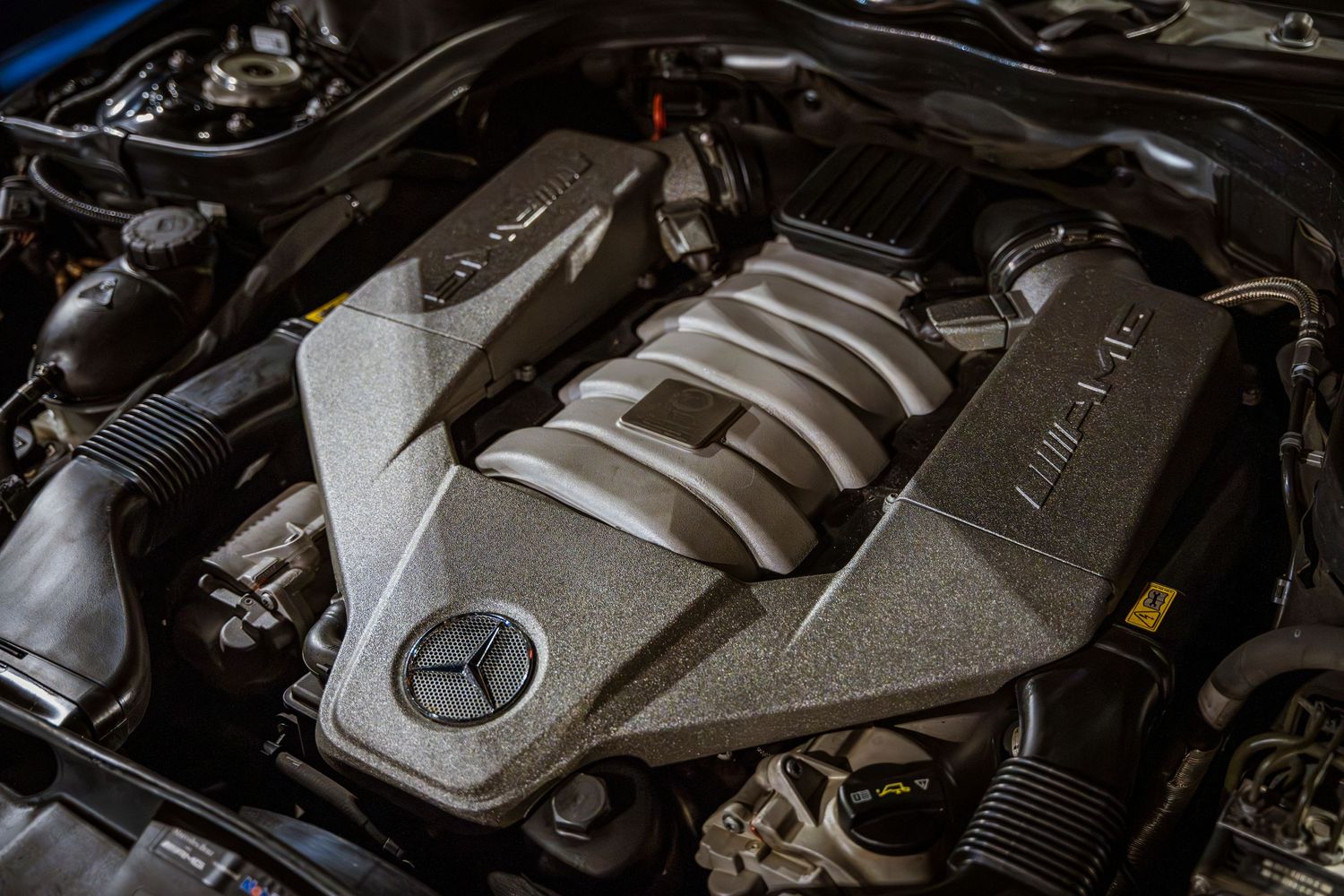 Close up of Mercedes-Benz AMG engine bay showing silver engine cover.