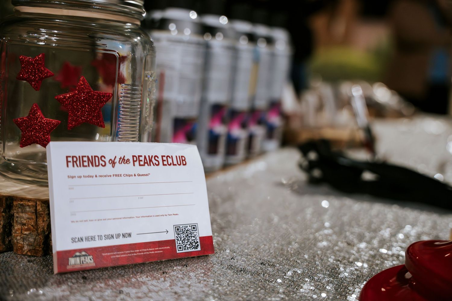 Glass jar display with member cards for a car enthusiast club.