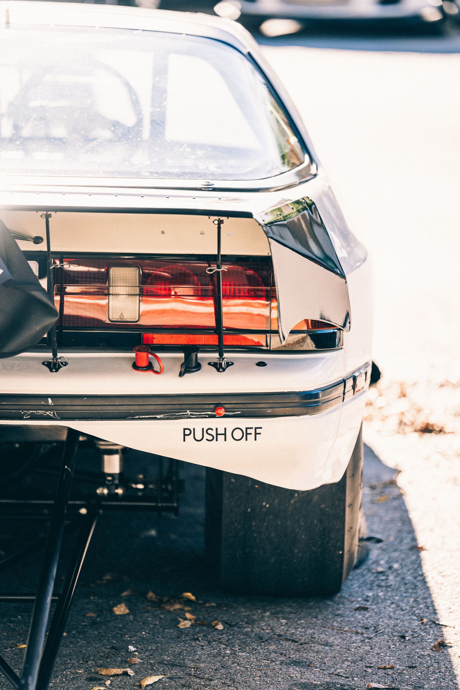 Close up of vintage car rear end showing Push Off text and exposed mechanical components.