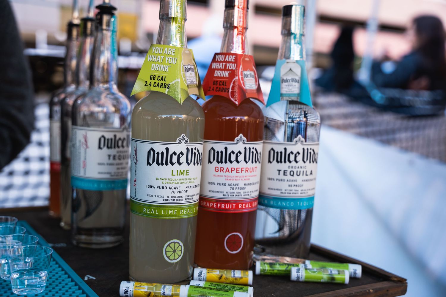 Row of colorful Quikchill beverage bottles displayed at a bar setup.