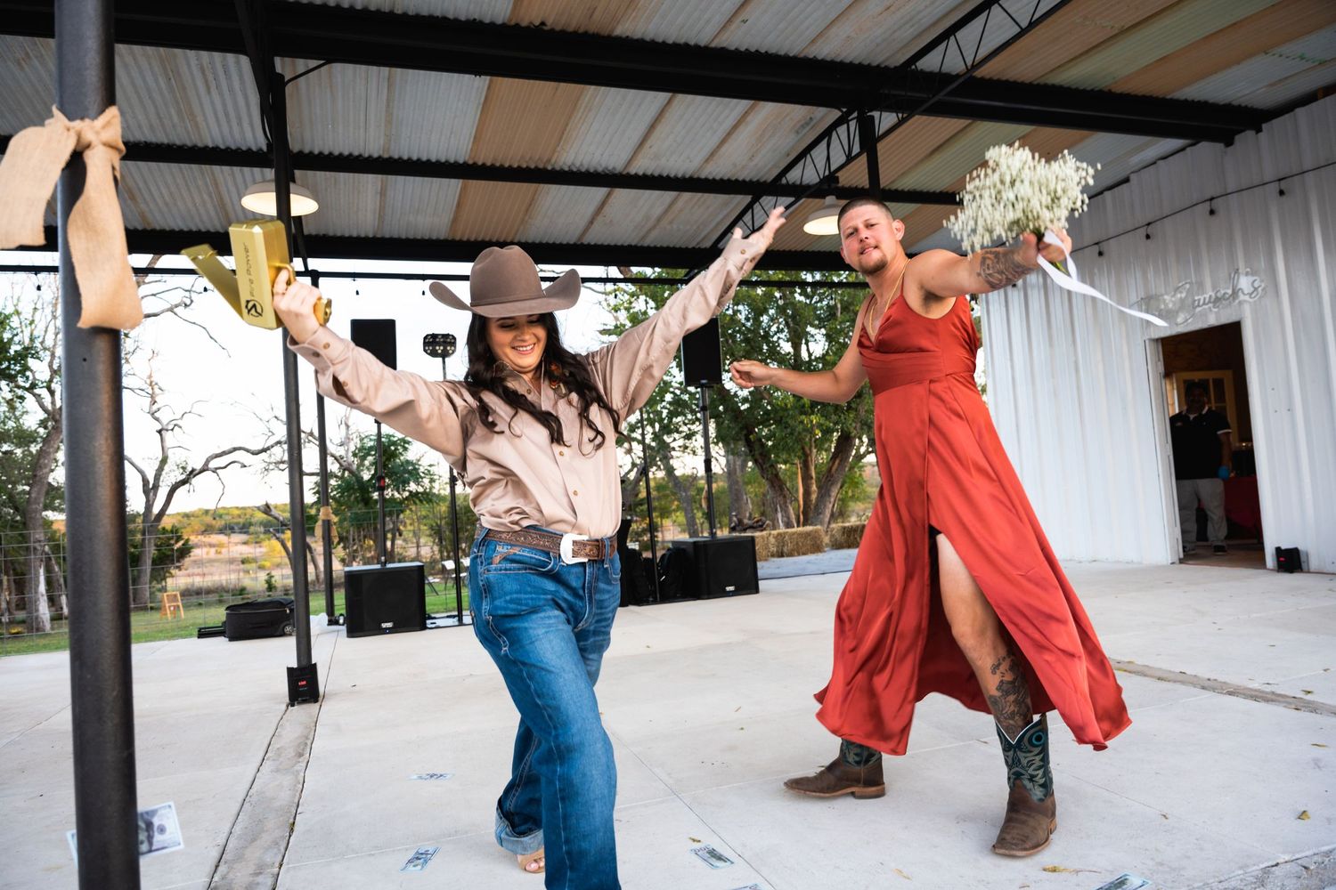 Western-themed dancers perform choreographed moves at covered outdoor venue.