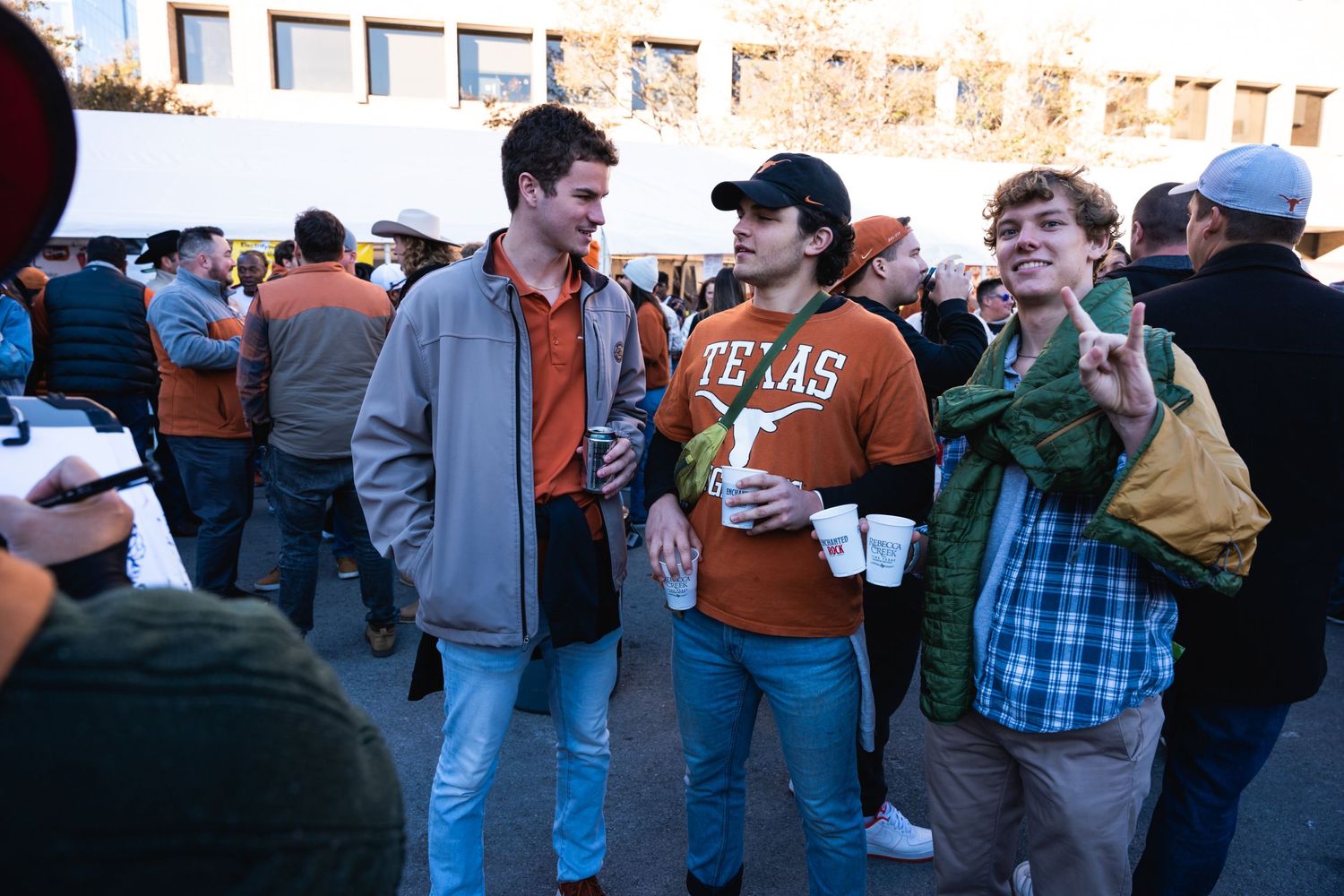 Casual gathering of young people socializing at an outdoor event.