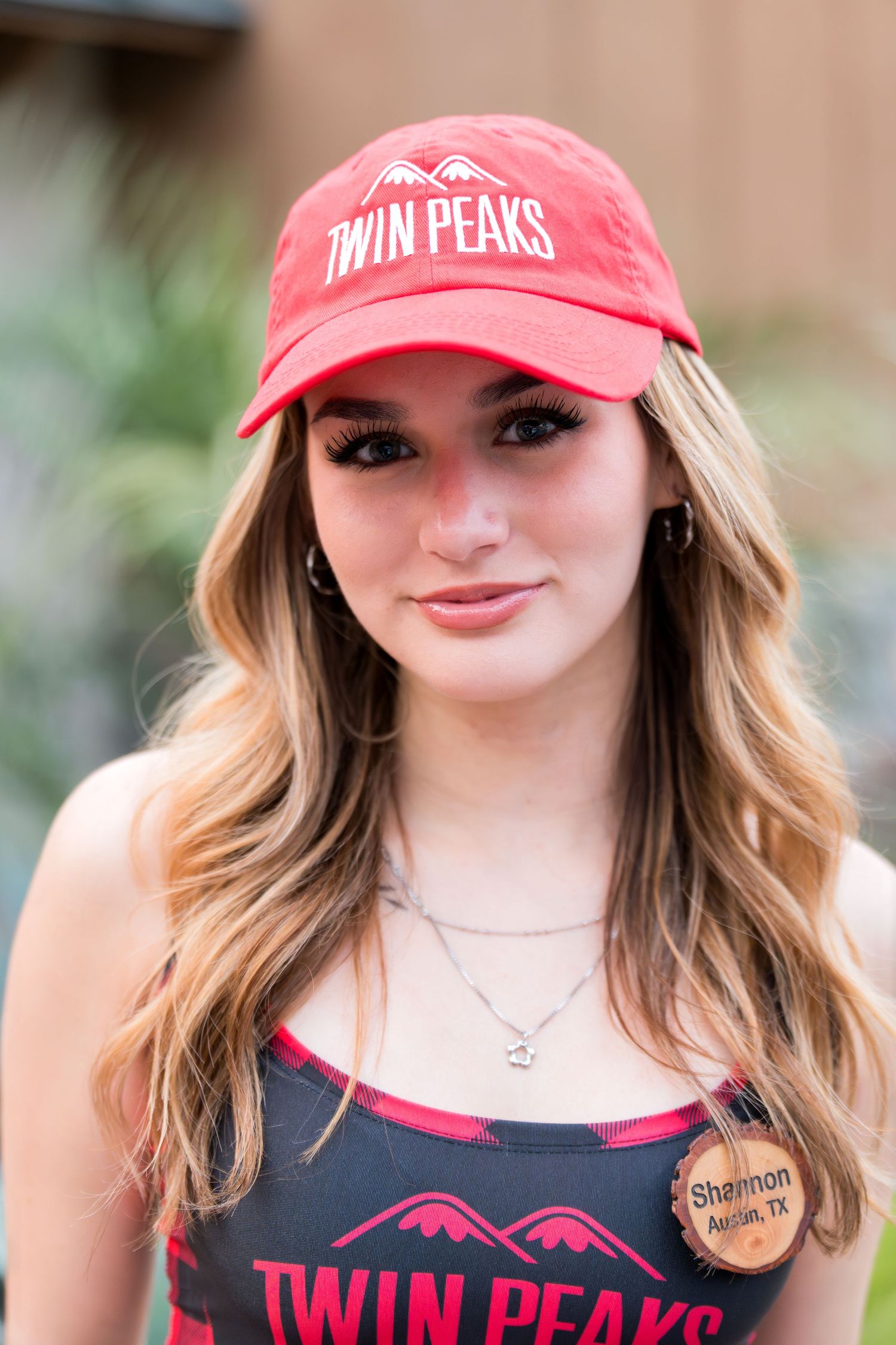 Red Twin Peaks branded baseball cap and matching tank top merchandise.