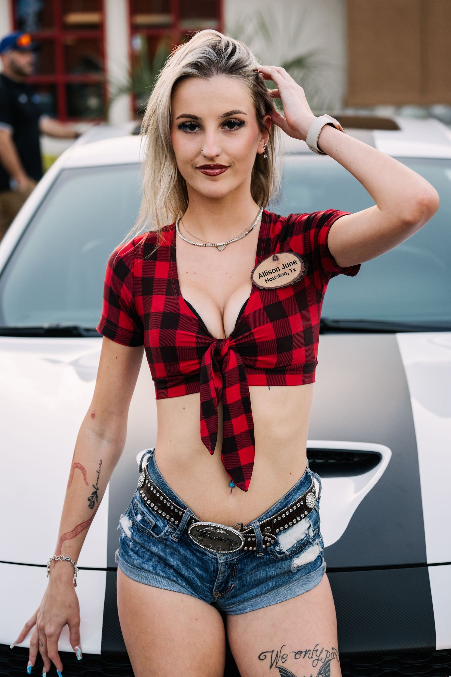 Server in plaid crop top and denim shorts at Twin Peaks restaurant.