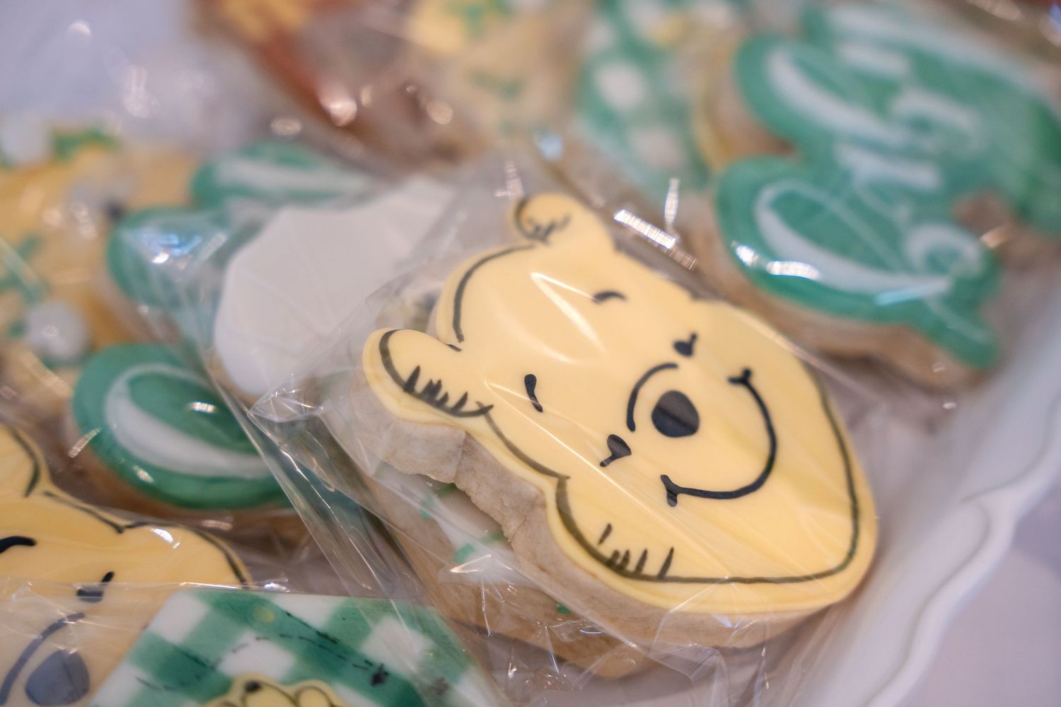 Close-up of decorated sugar cookies featuring Winnie the Pooh characters in clear packaging.