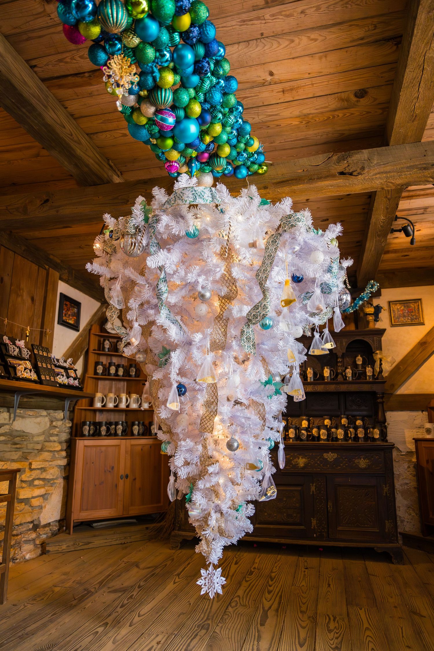 Stunning holiday display featuring blue and green ornaments cascading into a white crystalline structure.