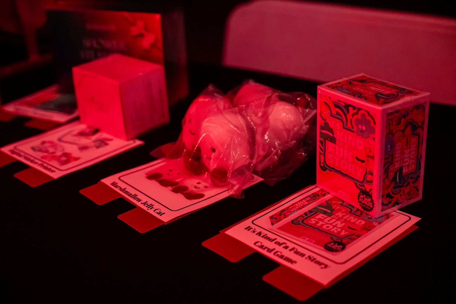 A sequence of red-tinted darkroom photographs being developed in chemical solution under safelight conditions.