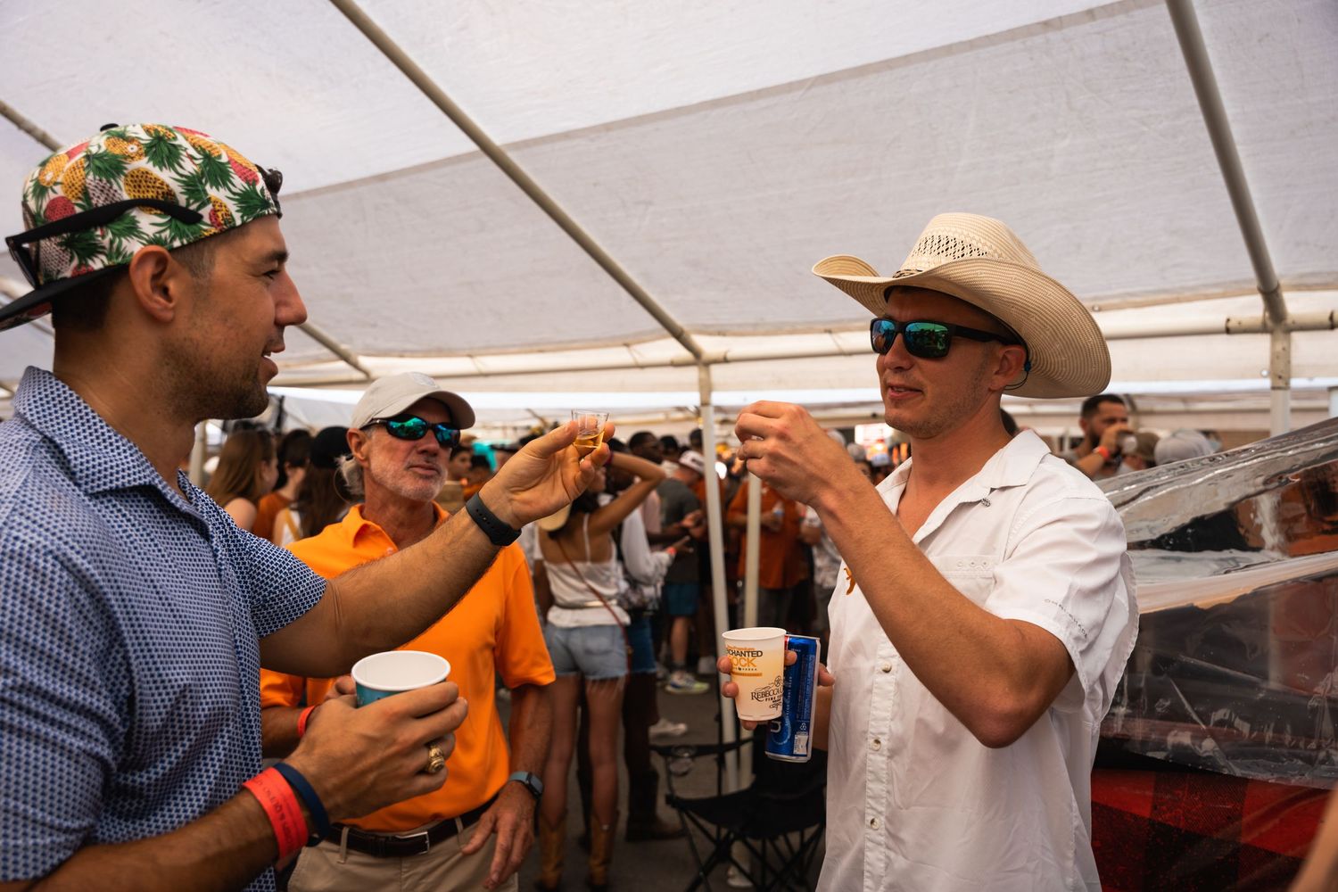 Two fans engaged in spirited conversation during a tailgate party.