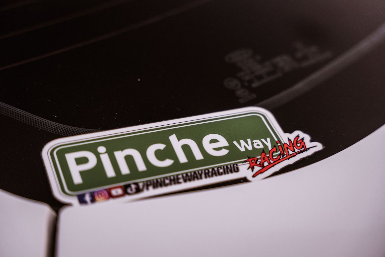 Close-up of a Pinche Way automotive sticker on a dark surface.