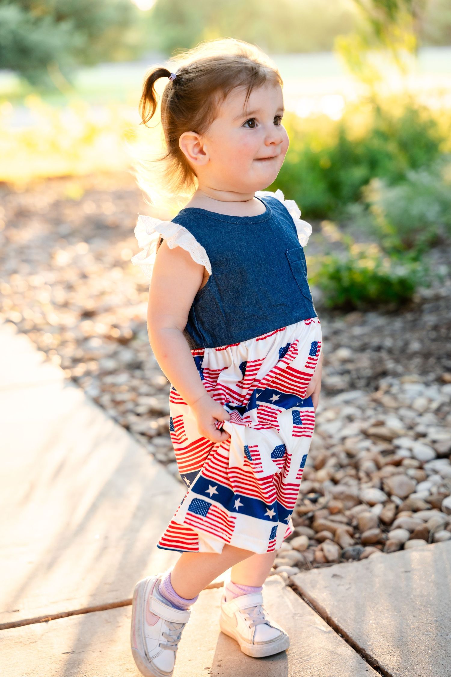 A patriotic outfit featuring red, white and blue patterns is worn outdoors on a sunny day.