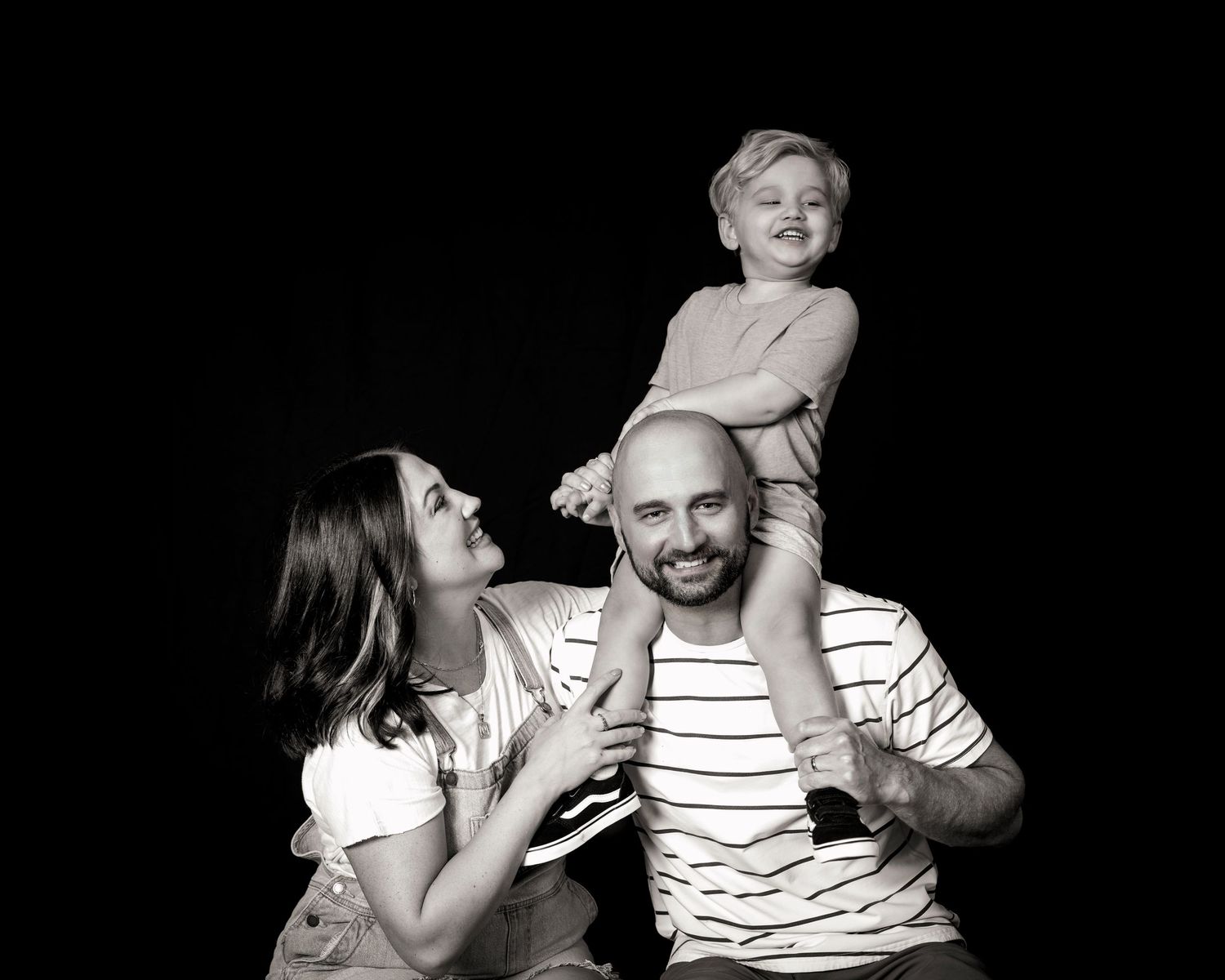Black and white studio portrait showing joyful interaction.