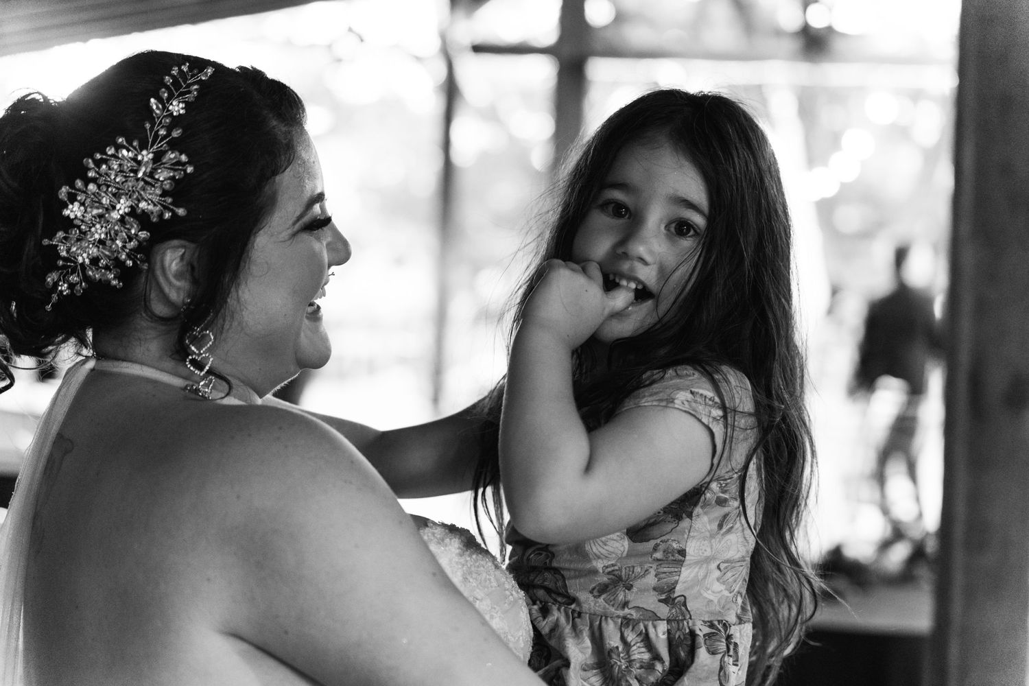 A touching candid black and white moment during wedding celebrations.
