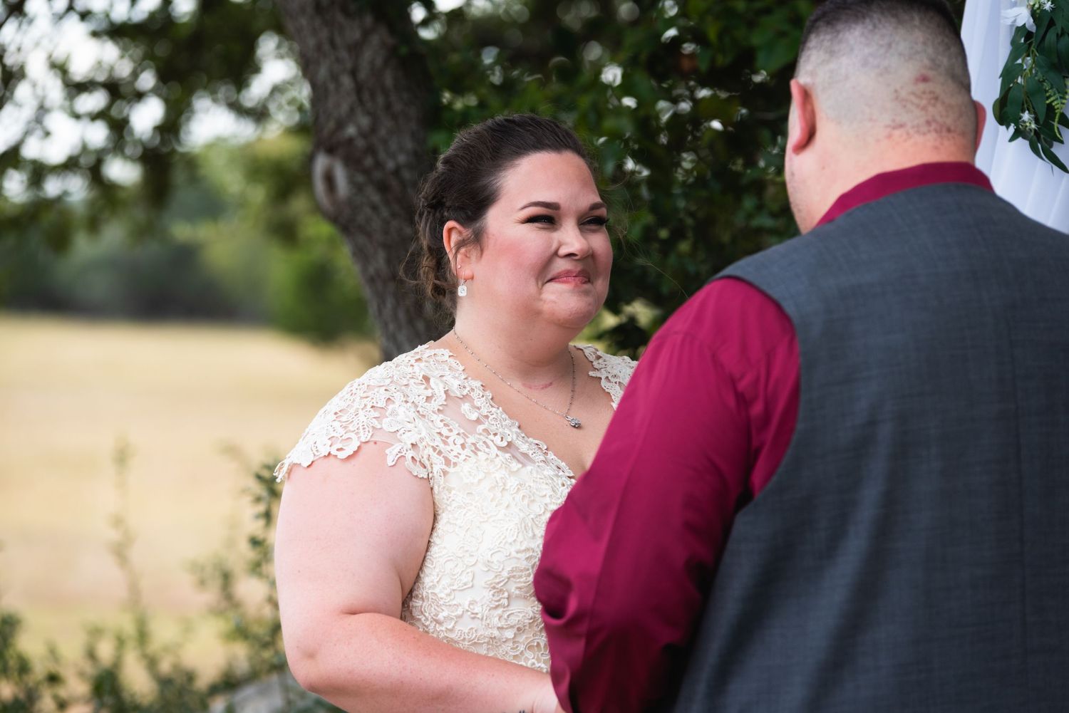 A couple shares an intimate moment during their outdoor wedding ceremony.