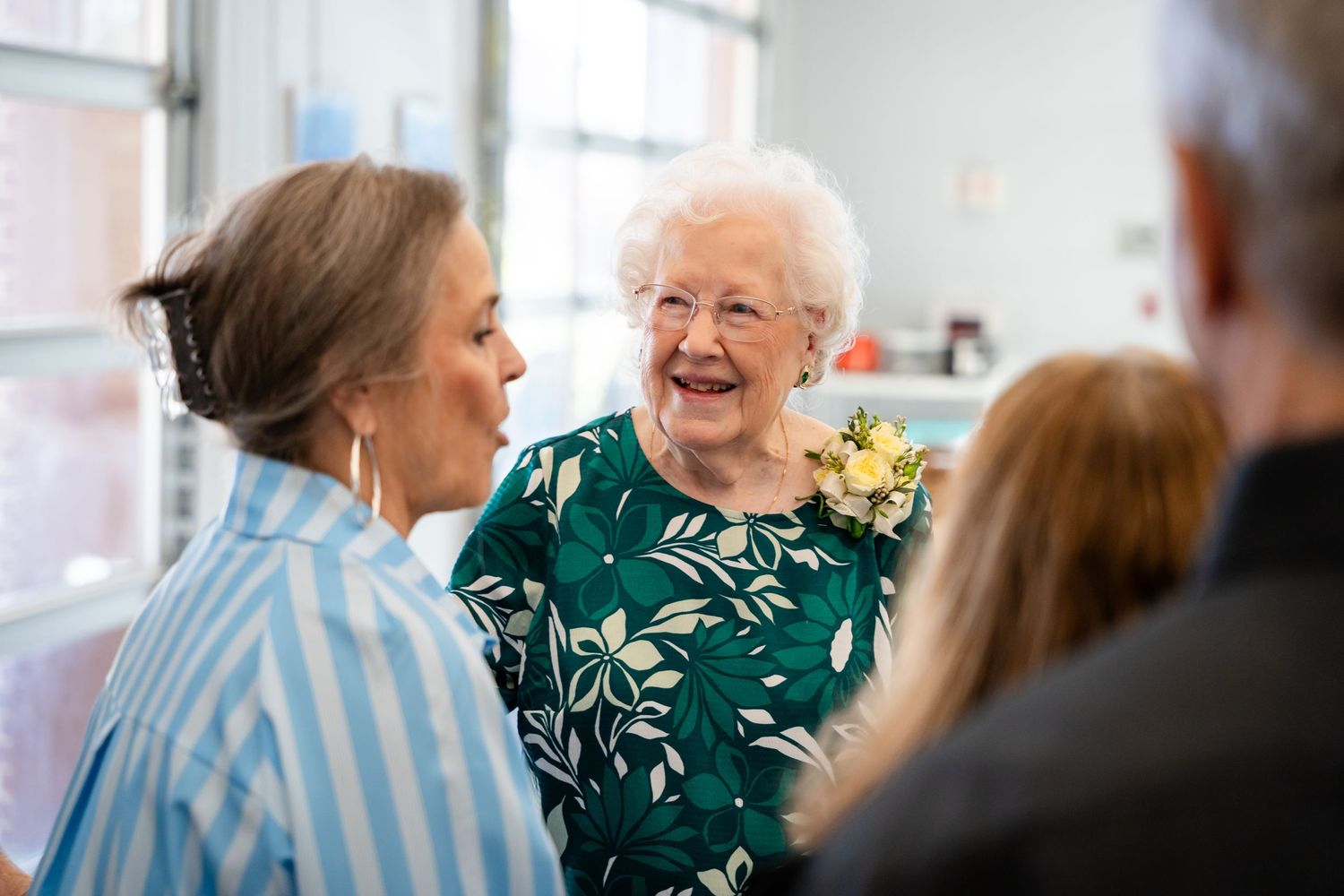 A joyful moment shared between people at an indoor gathering.