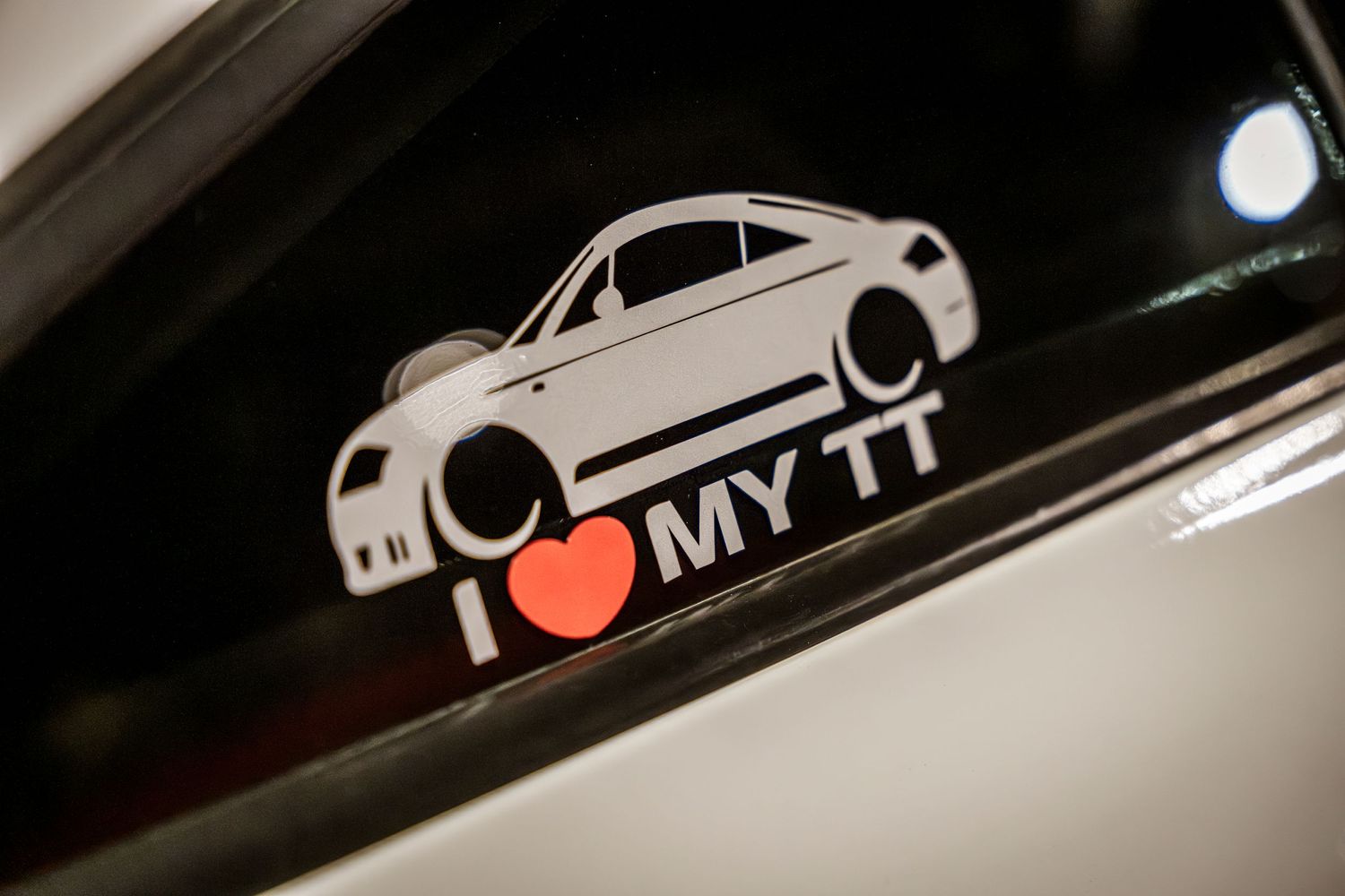 Car decal sticker showing 'I love my TT' with stylized vehicle silhouette.