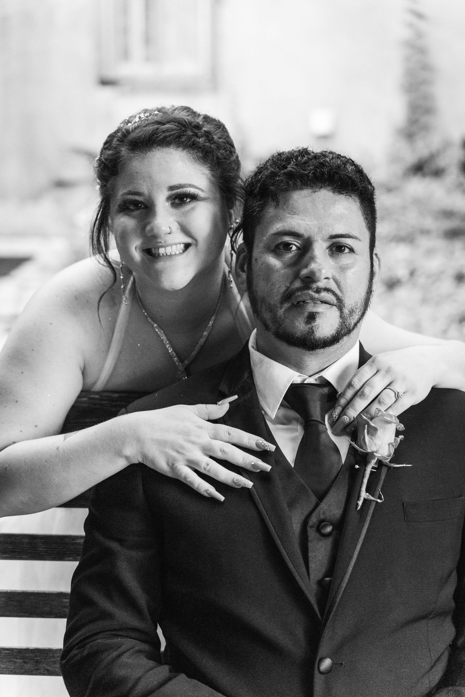 A black and white portrait of newlyweds sharing an intimate moment together.