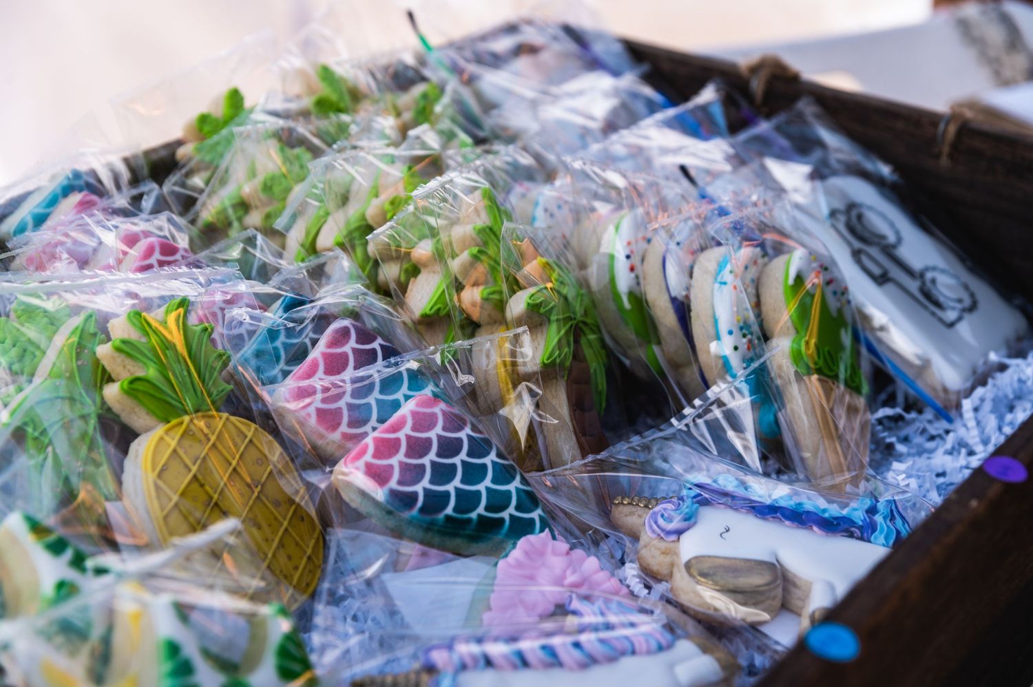 Colorful mermaid-themed items wrapped in plastic bags displayed at a market.