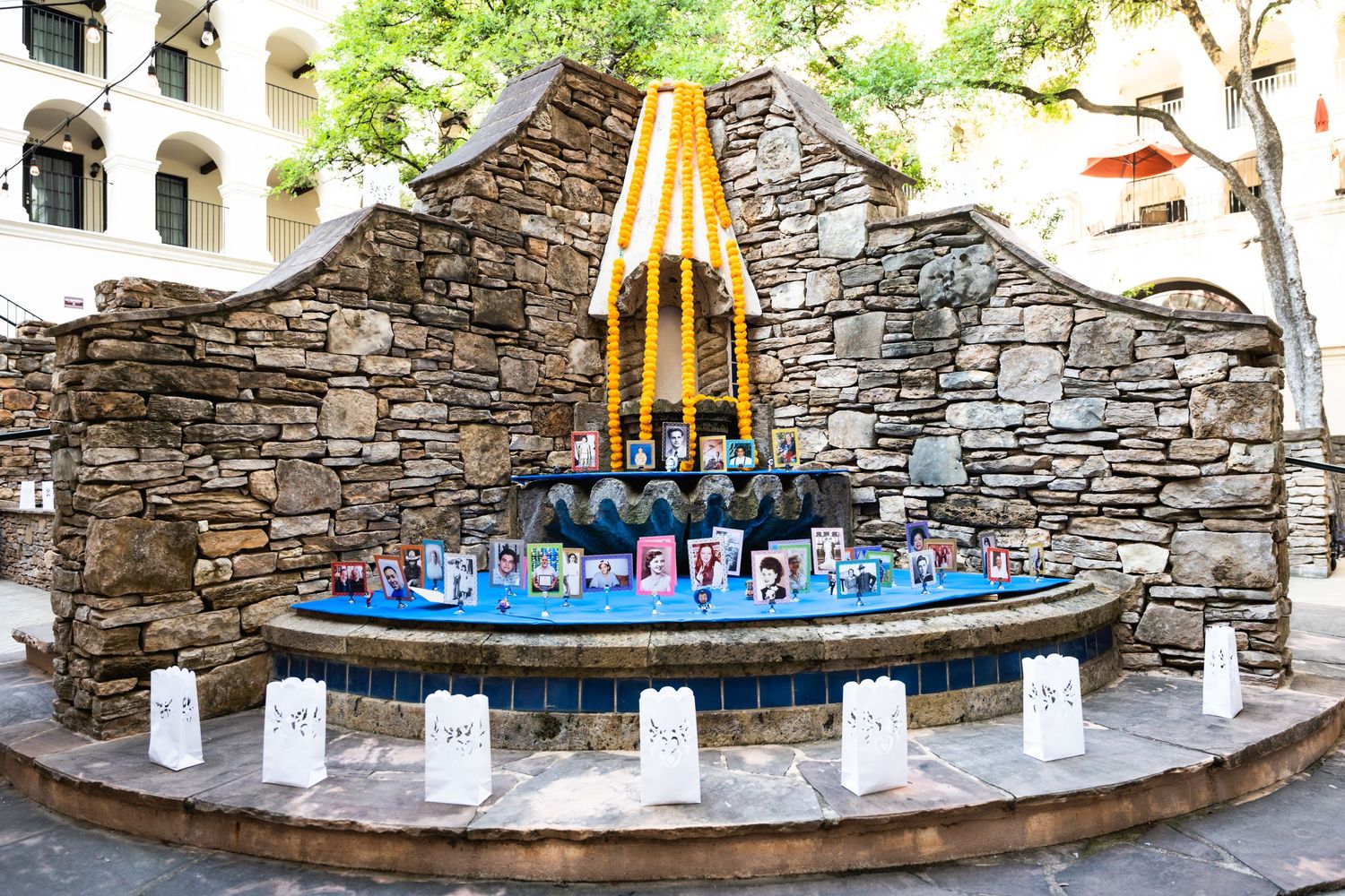 Decorative stone fountain display with illuminated candles and blue lighting at an event venue.