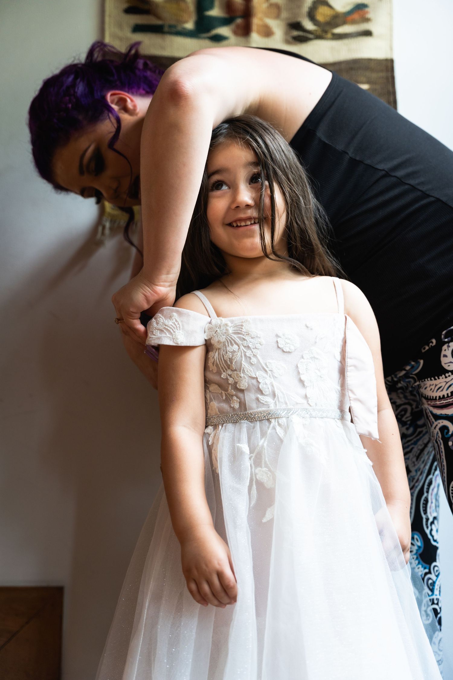 A heartwarming moment during dress fitting preparations.