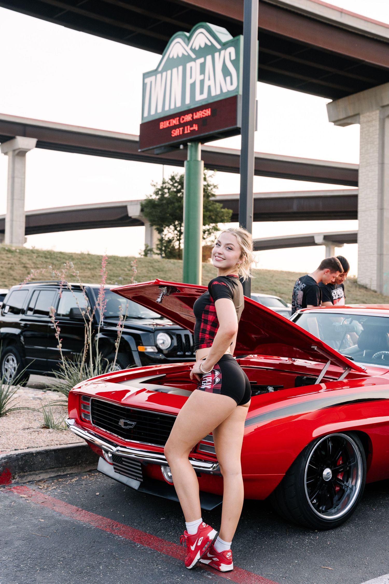 Classic red Camaro on display at Twin Peaks restaurant car show.