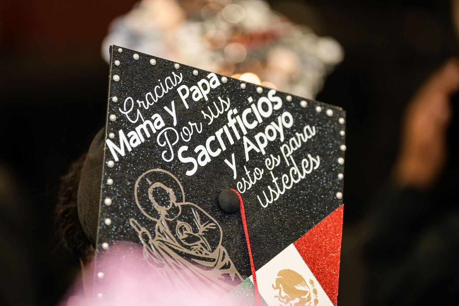 A graduation cap featuring mariachi-themed artwork and Spanish text in white lettering.