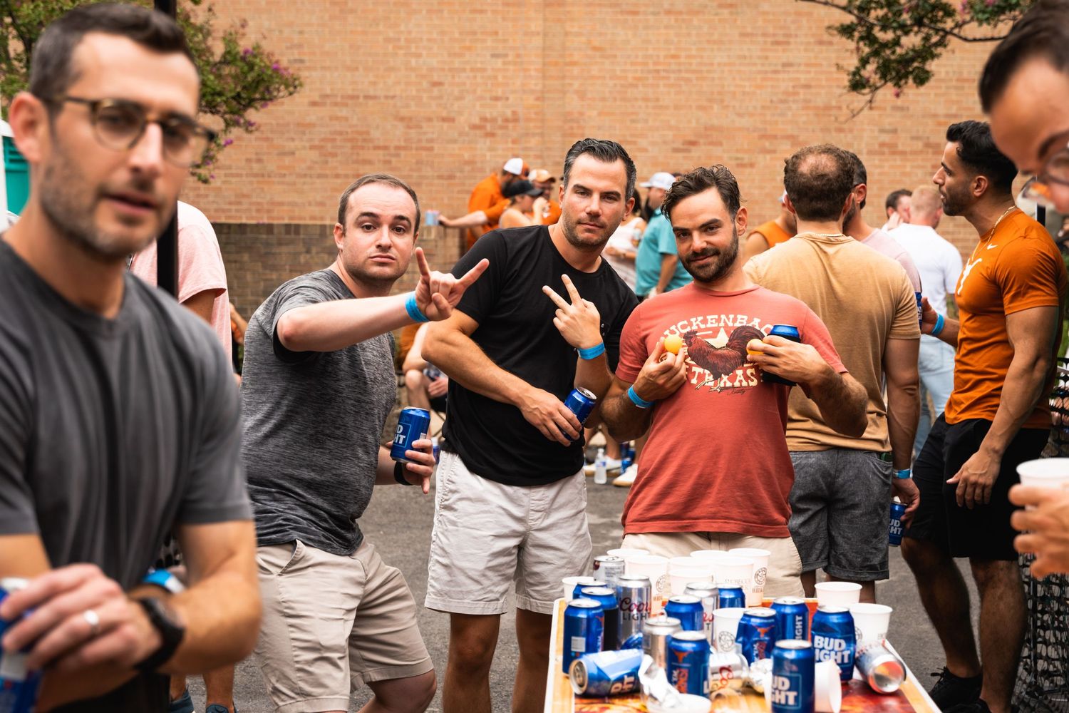 Group of friends enjoying drinks and conversation at casual outdoor gathering.