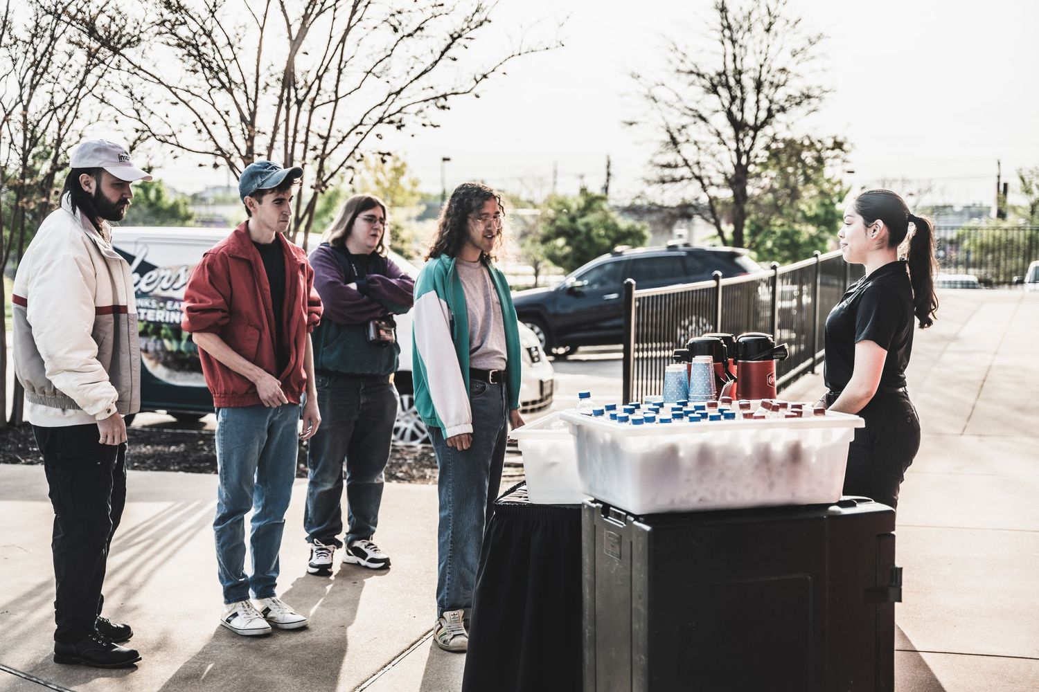 Outdoor vendor setup at a car show with merchandise displayed on a table.