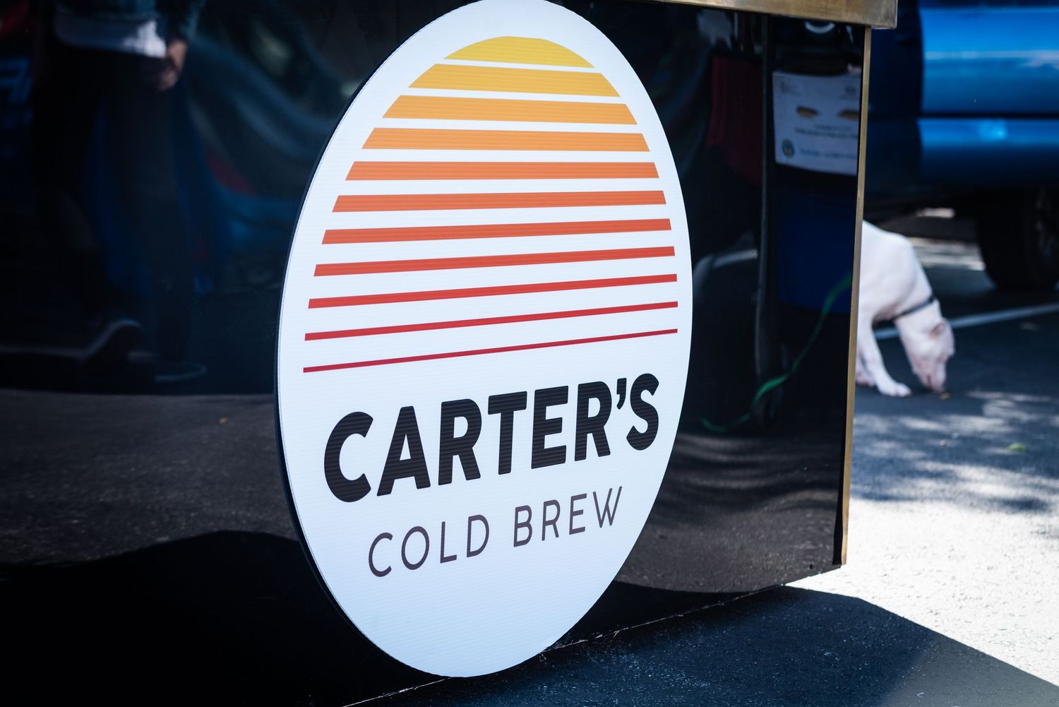 Carter's Cold Brew retro-style logo with orange and red sunset stripes.