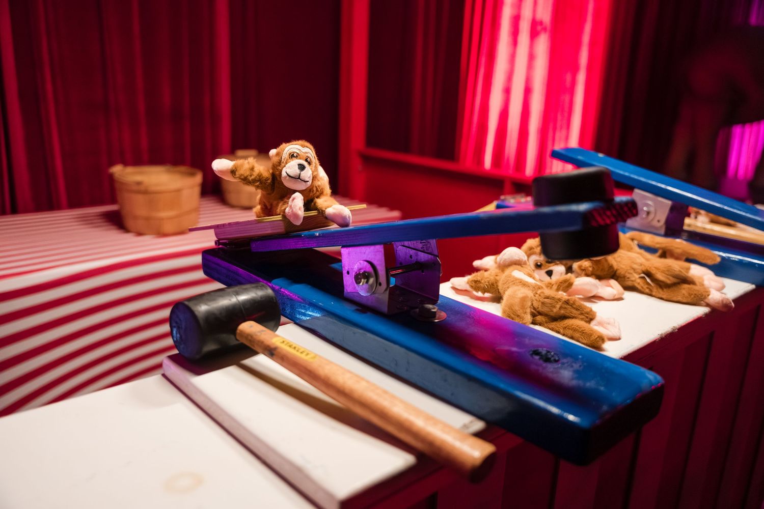 Wooden carpentry tools and a blue measuring tape arranged on a red surface with dramatic lighting.