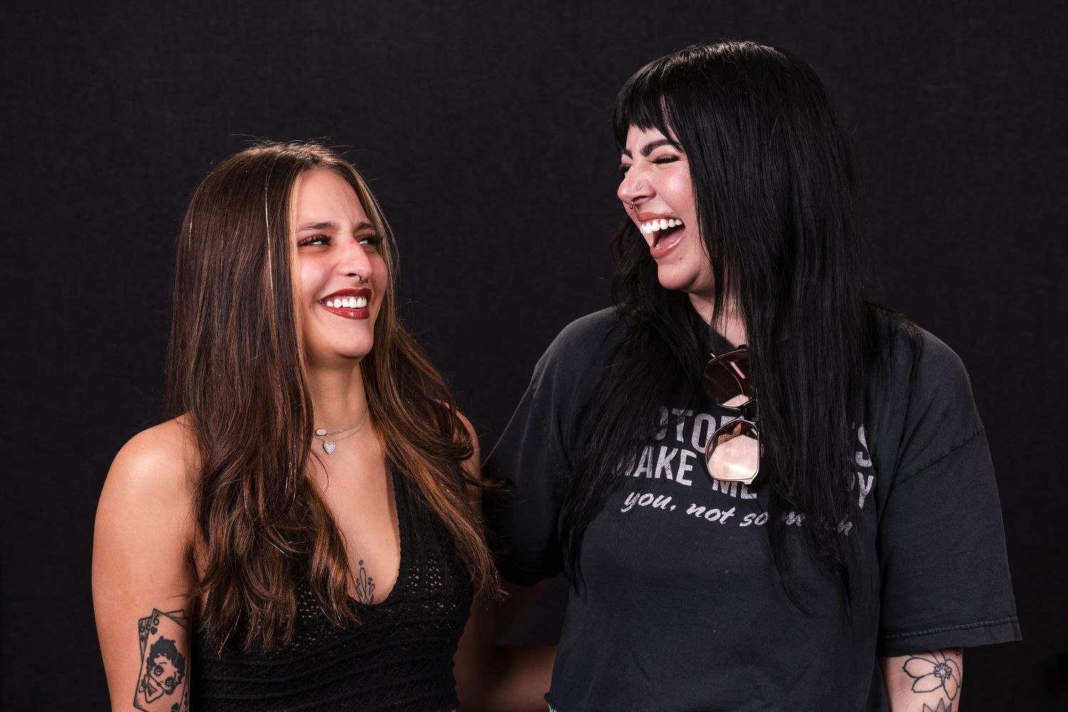 Two people share genuine laughter together against a dark background in a candid photo sequence.