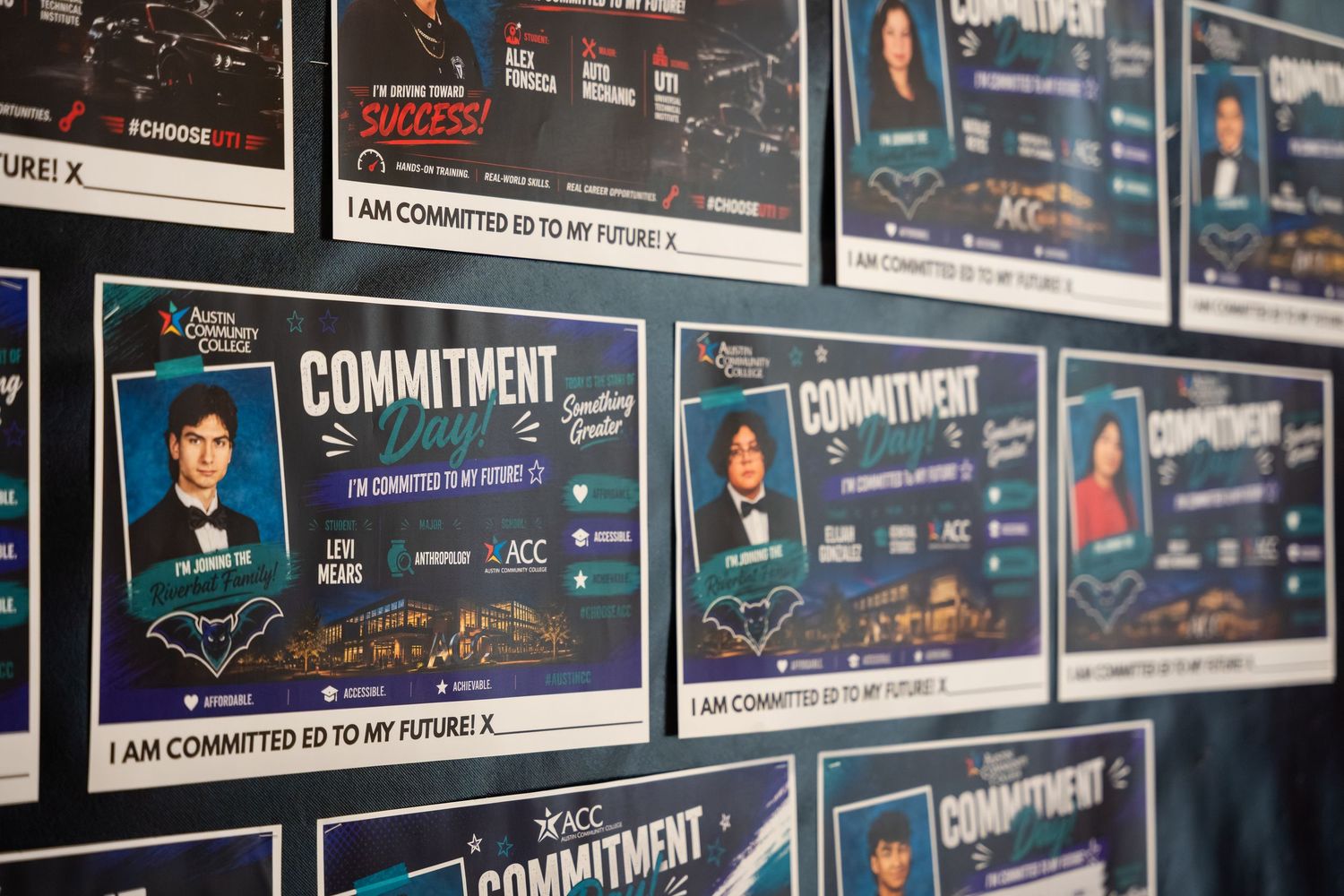 Students display commitment pledge cards on a wall at ACC college signing event celebrating future academic goals.