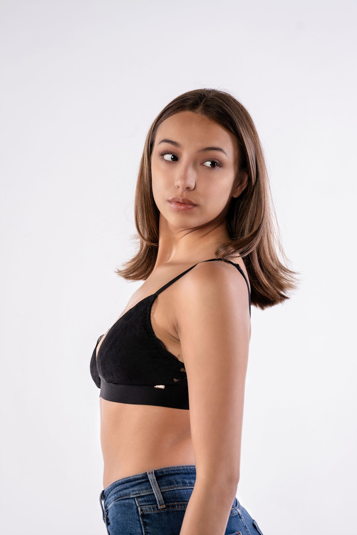 Side profile fashion portrait against white studio background.