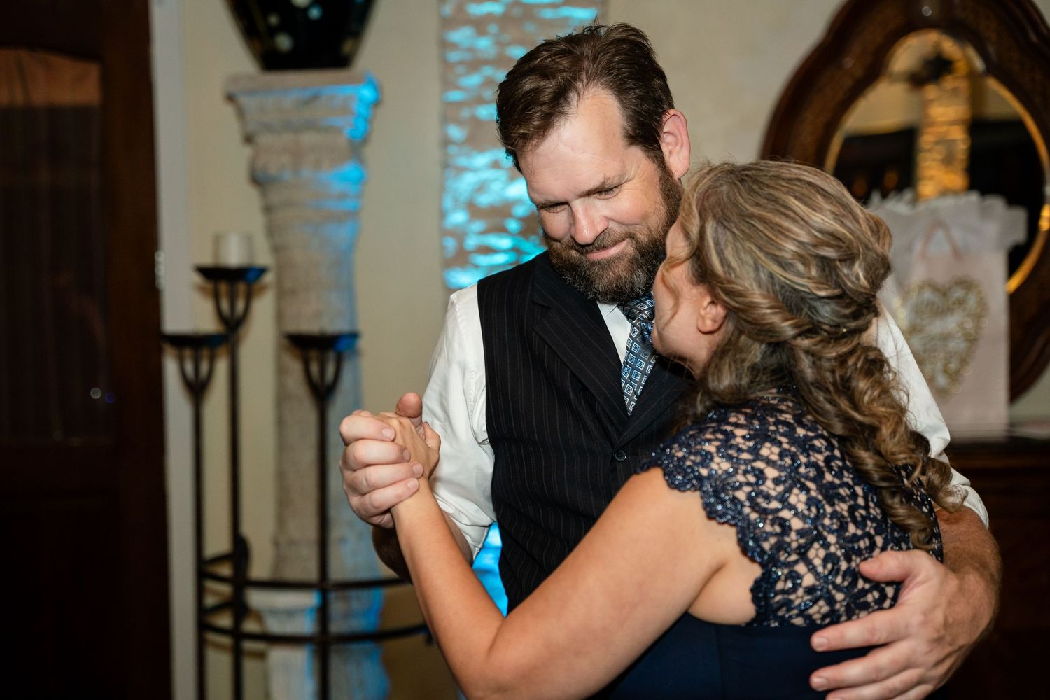 A couple shares an intimate slow dance during an evening reception.