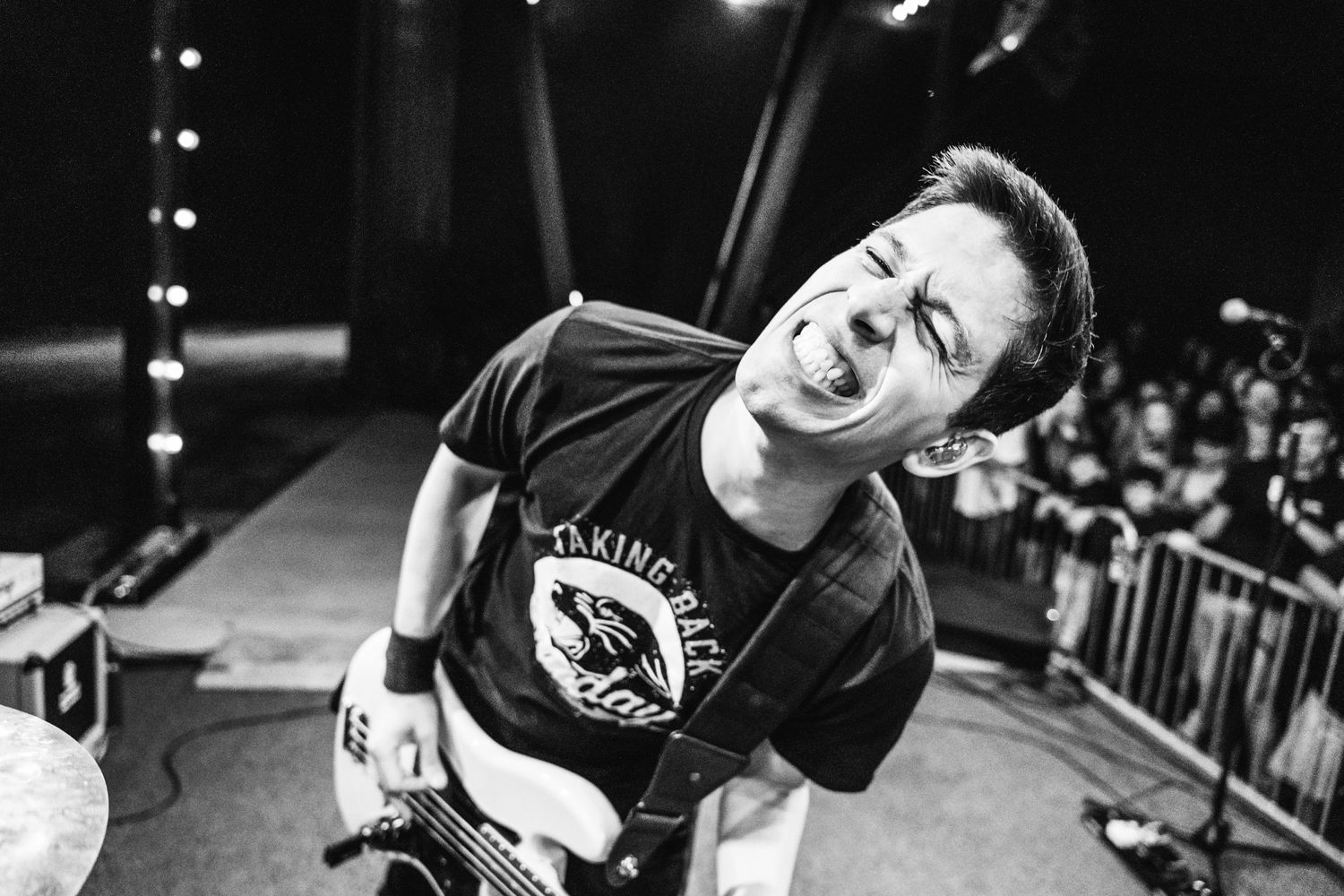 Black and white photo of musician performing passionately on stage.