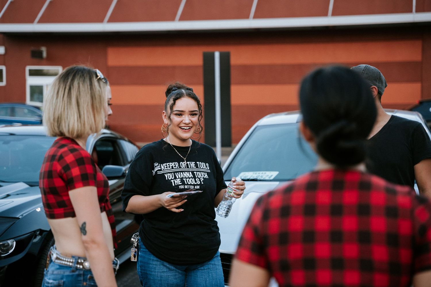 Casual conversation between attendees at an automotive gathering.