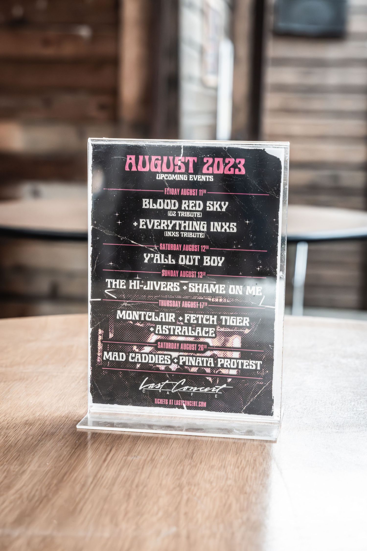 Concert schedule flyer for August 2023 showing multiple band performances.